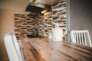a kitchen with a counter with a sink and a counter top at Centrum Apartment in Valga