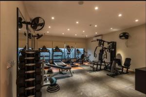 a gym with several treadmills and machines in a room at Luxor Apartments & Suites - Opus in Lahore +18 photos