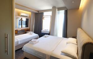 a hotel room with two beds and a window at Upper House in Kaş +58 photos