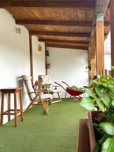 two chairs and a table in a room with green carpet at Lake house Sreten in Šavnik