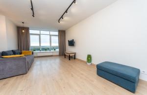 a living room with a couch and a table at Европейска площа in Kyiv +4 photos