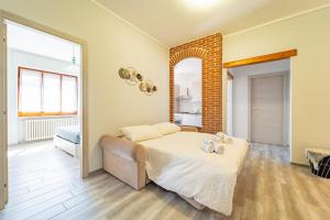 Кровать или кровати в номере Elegante Appartamento con Terrazzo - Parcheggio Gratuito Privato & Wifi