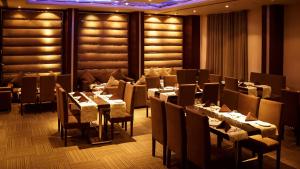 a restaurant with tables and chairs in a room at Silver Palm Hotel & Resorts in Malaut