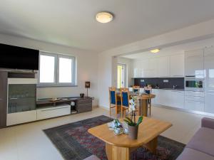 a large living room with a table and a kitchen at Apartment Maestral in Poreč