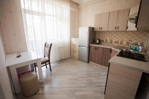 a small kitchen with a refrigerator and a table at SelfHouse in Masazır
