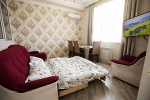 a bedroom with a bed and a table and a window at SelfHouse in Masazır