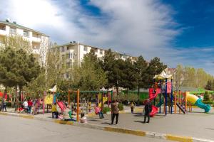 a group of children playing on a playground at SelfHouse in Masazır