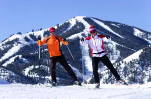 two skiers standing on top of a snow covered slope at Sun Valley Resort in Sun Valley