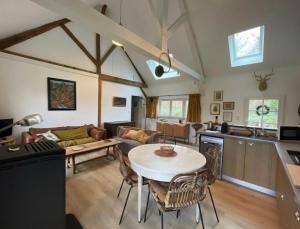 a kitchen and living room with a table and chairs at La Sauvagine in Villemurlin
