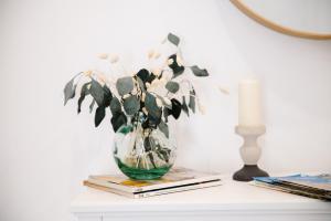a vase with flowers in it sitting on a table at Douro's Heart Stay in São João da Pesqueira