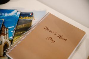 a spiral notebook with the words johnnies breath written on it at Douro's Heart Stay in São João da Pesqueira