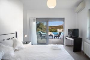 Posteľ alebo postele v izbe v ubytovaní Gramvousa Villas