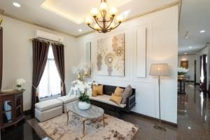 a living room with a couch and a table at Modern Lanna Style Grand Pool Villa in Chiang Mai