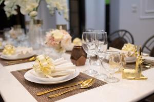 a table with plates and wine glasses on it at Modern Lanna Style Grand Pool Villa in Chiang Mai +73 photos