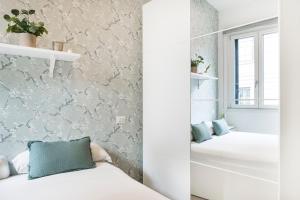 A bed or beds in a room at Easylife - Comodo trilocale in Porta Romana