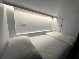 Una cama o camas en una habitación de WANGTA Hostel