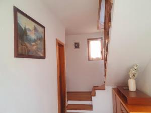 a room with a staircase with a painting on the wall at Apartma Suzy in Bovec