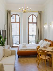 a living room with a bed and a table at Kołłątaja 23 Apartments in Wrocław