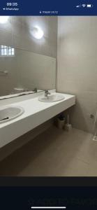 a bathroom with two sinks and a large mirror at Villa Zara in Zanzibar City +8 photos