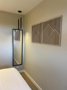 a room with a bed and a mirror on a wall at Studio 137 in Zwaag