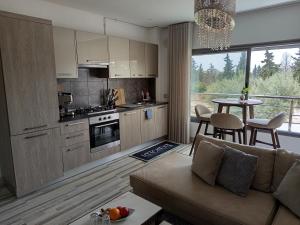 a kitchen and living room with a couch and a table at Florida Studio Hammamet Nord in Hammamet Nord