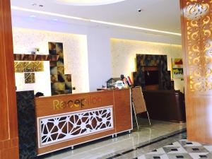 a lobby with a reception desk in a building at Virar Hotel Erbil in Erbil