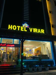a hotel window with a hotel vtar sign on it at Virar Hotel Erbil in Erbil