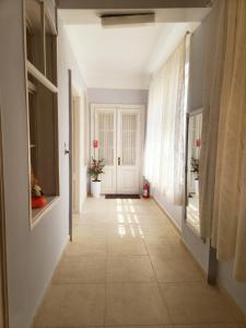 a hallway with a white door and a tile floor at BIG APARTMAN BELA CRKVA in Bela Crkva