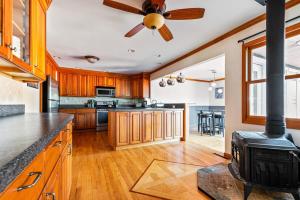 a kitchen with wooden cabinets and a stove at HV Spacious Retreat sleeps 13 with pool and hot tub in Poughkeepsie