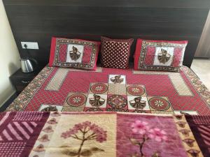 a bed with four pillows and a blanket on it at Tree Valley Homestay Chail in Chail