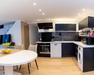 a kitchen with a white table and a white counter top at Verdure & Cie in Saint-Pierre