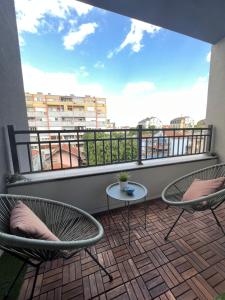 a balcony with two chairs and a table at Golden Royal SM in Kragujevac