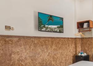 a flat screen tv hanging on a white wall at Khách sạn gần biển Viva Tuy Hoà Phú Yên in Phường Sáu