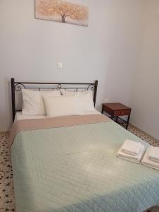 a bedroom with a bed with two towels on it at KP Apartments Classic in Mytilini +31 photos