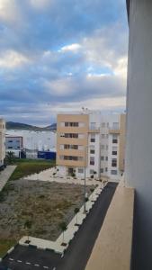 a view of a large building with a parking lot at Apartement near the Airport and beach Gzenaya in Gzennaïa +6 photos