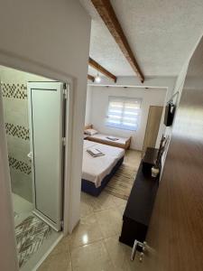 a small room with a bed and a bathroom at Villa Miki in Kruče +5 photos