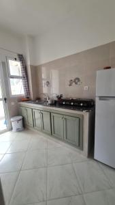 a kitchen with a sink and a refrigerator at Apartement near the Airport and beach Gzenaya in Gzennaïa