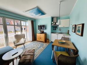 a living room with a table and a kitchen at Villa Luisa in Timmendorfer Strand
