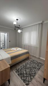 a bedroom with a large bed and a rug at My Trabzon trend house in Trabzon