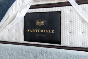 a suitcase with a passport on a bed at Affittacamere Manì - Camere e Appartamenti in Gela +38 photos