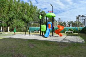 a park with a playground with a slide and a swing at Lovely apartment in Santo Domingo in Villa Mella