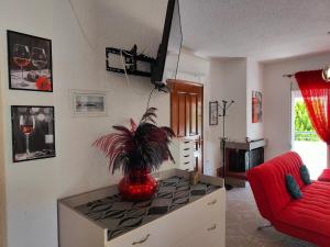 a living room with a vase with a plant on a counter at Dimana Maisonette, 150m from Fourka Beach in Skála Foúrkas +15 photos