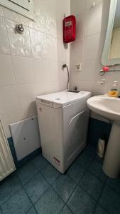 a small white bathroom with a sink and a counter at Το Φιλόξενο Σπιτάκι! - The Friendly Nest ! in Paralion astros
