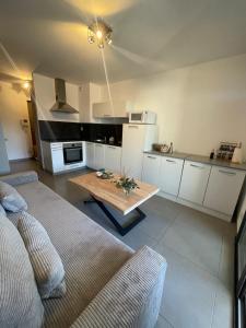 a kitchen with a couch and a table in a room at Apartment Propriano, Corsica in Propriano +13 photos