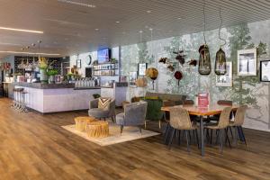 a restaurant with a table and chairs and a counter at M4 Apartments in Freiburg im Breisgau