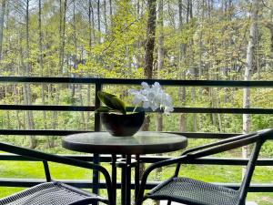 a table with a vase of flowers on a porch at Seaside apartments 3 in Palanga