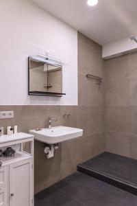 a bathroom with a sink and a mirror at M4 Apartments in Freiburg im Breisgau