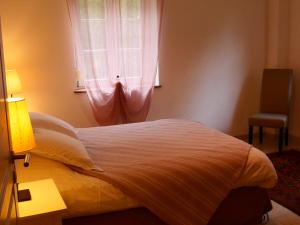 a bedroom with a large bed with a window at Gite Coquelicot Ferme du Domaine Les Bachats Rhodes in Rhodes