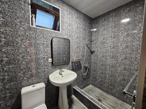a bathroom with a sink and a toilet and a mirror at Gudaleti Palace Private Countryside Villa near Tbilisi in Kaspi +20 photos