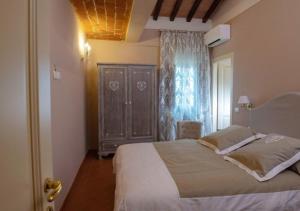 a bedroom with a large bed and a window at Tenuta Piroddi in Montemurlo +13 photos